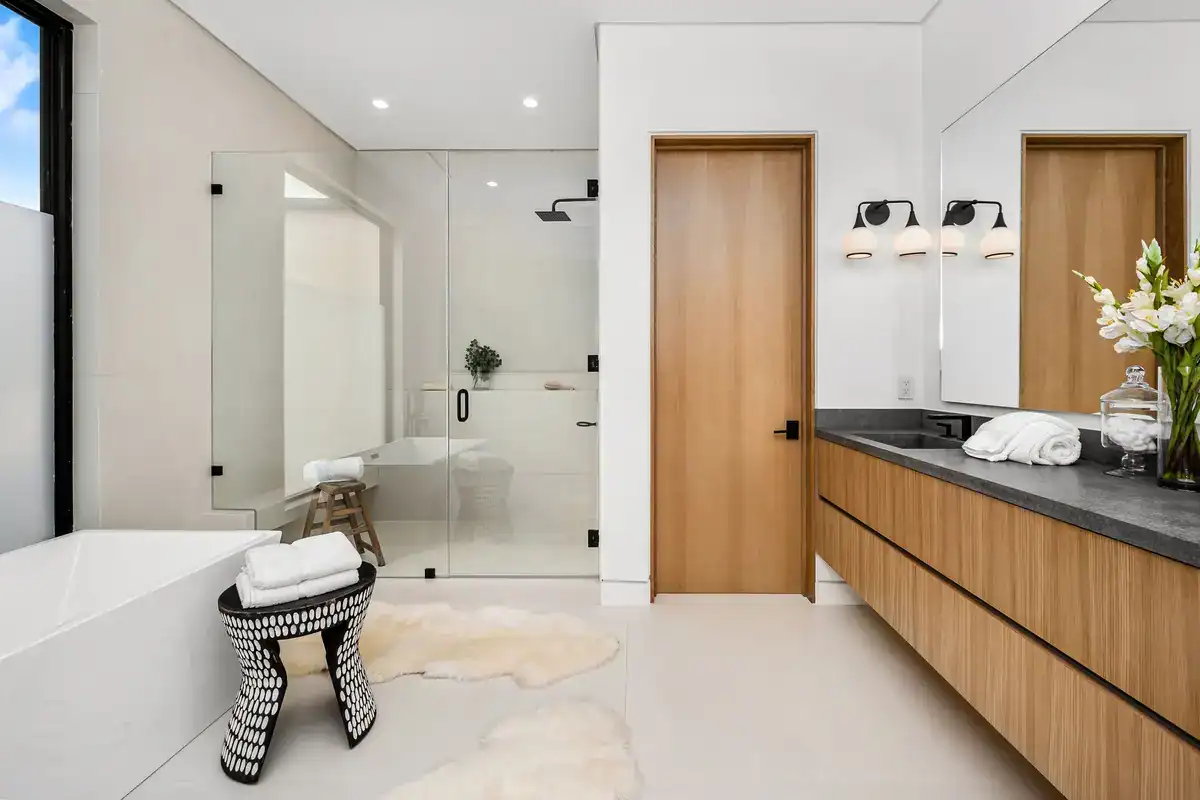 Elegant bathroom featuring contemporary design, wooden cabinetry, and modern lighting fixtures.