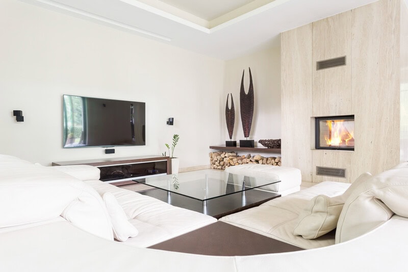 Modern living room renovation with fireplace, wood details, and sleek entertainment setup by Tixan Construction.