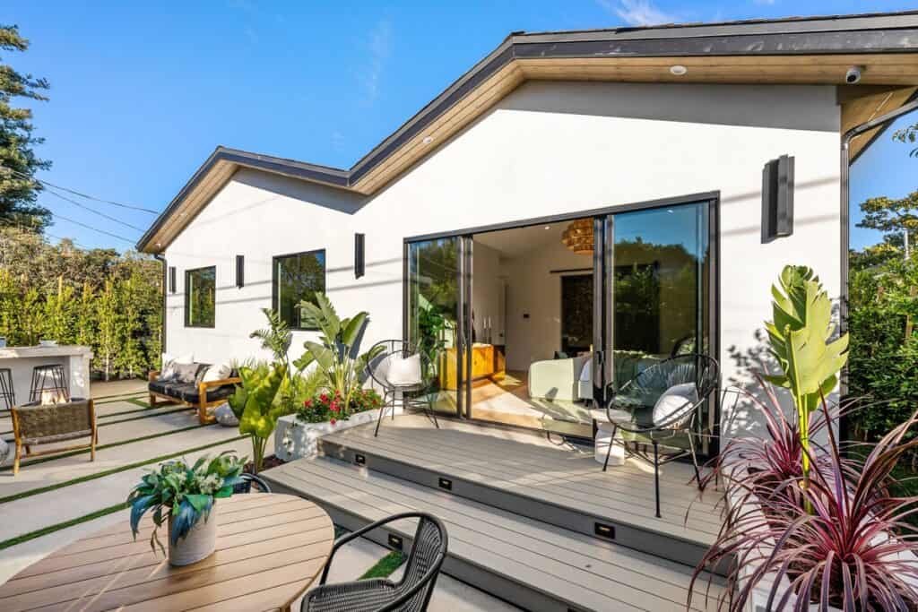 Modern ADU with private patio, sliding glass doors, and outdoor seating built by general contractor in Orange County.