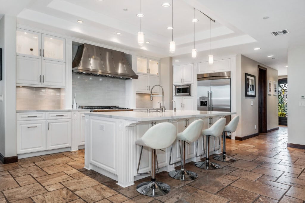 Fully renovated Orange County kitchen with white cabinets, hardwood floors, and stainless appliances