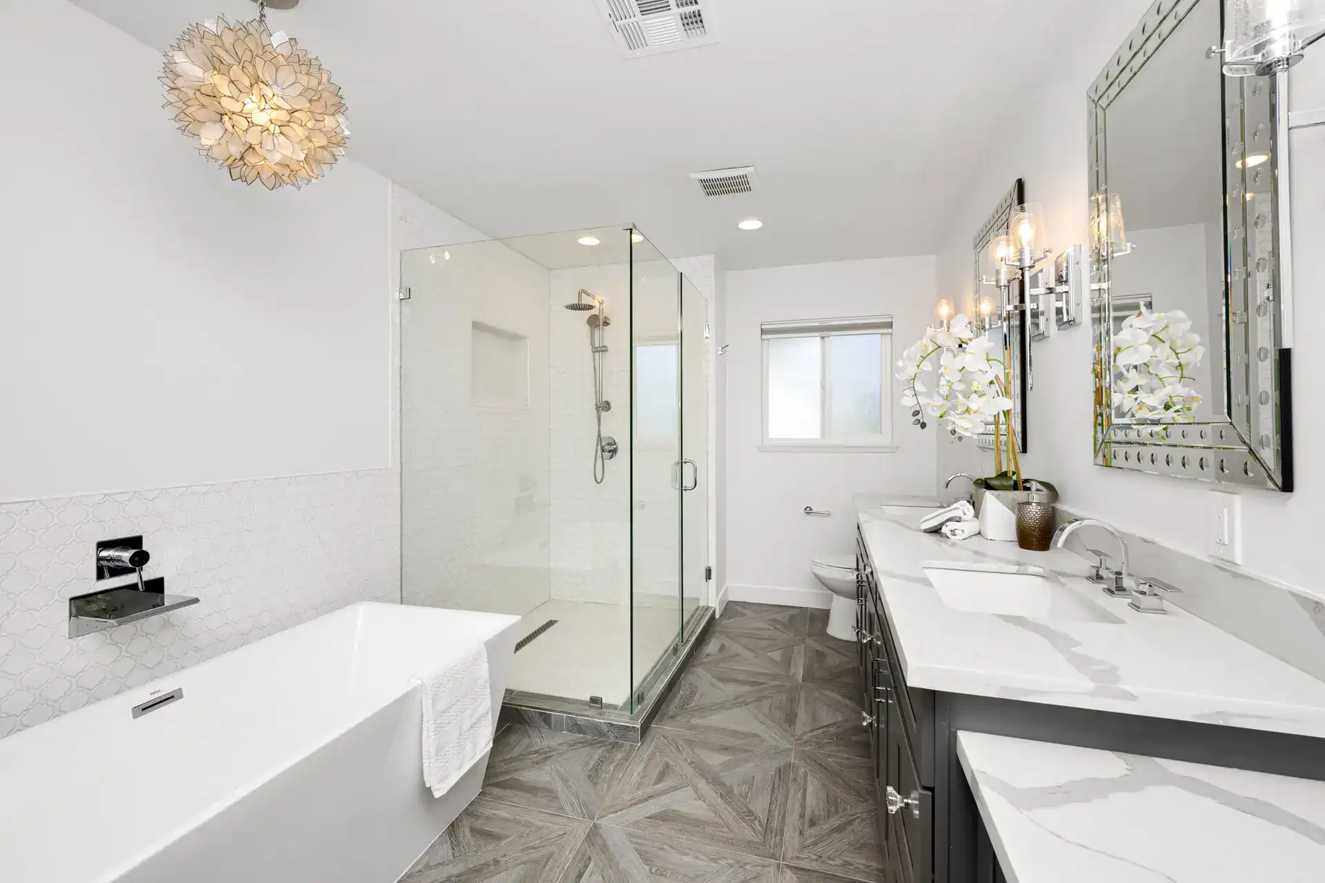 Modern bathroom with wooden floors, marble countertops, and stylish fixtures.