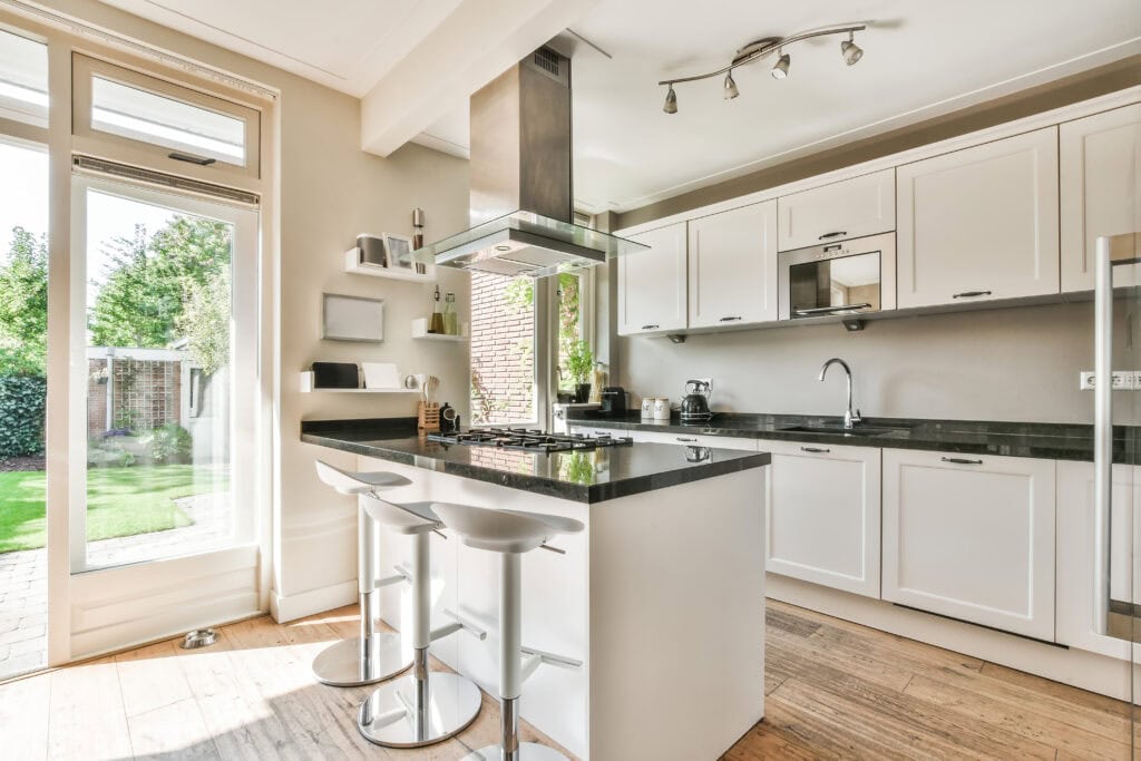 Beautiful finished kitchen renovation with island seating, pendant lighting, and tile backsplash
