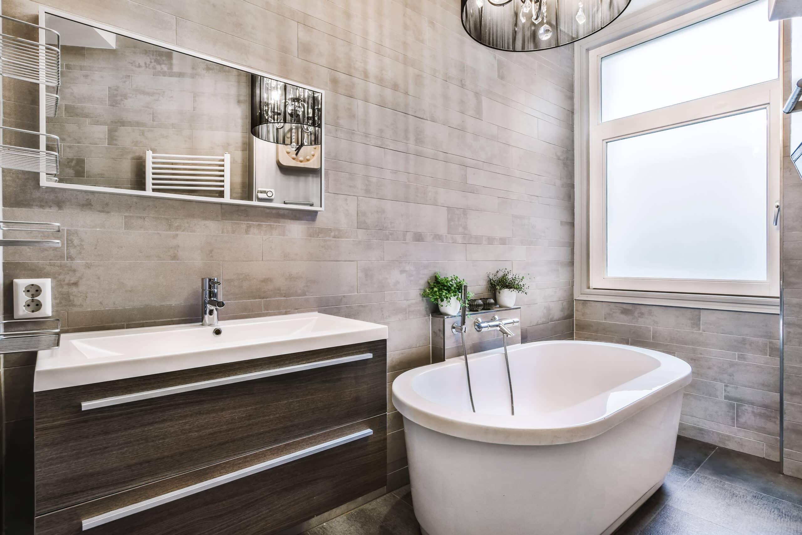 New bathroom fixtures installed with vanity, mirror, and lighting as final finishing touches