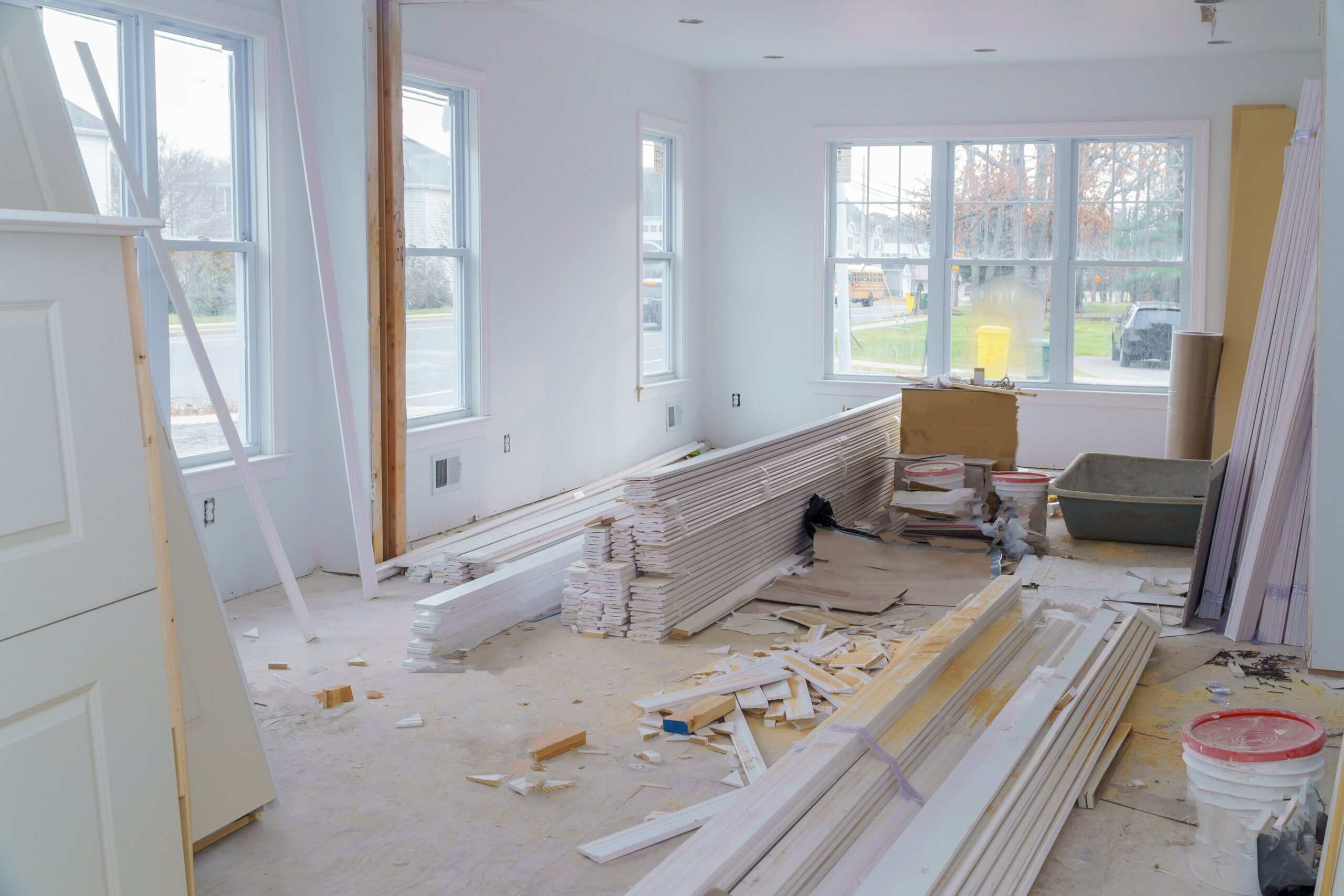 A home restoration contractor installing new drywall as part of a complete water damage repair project, returning the space to pre-loss condition.