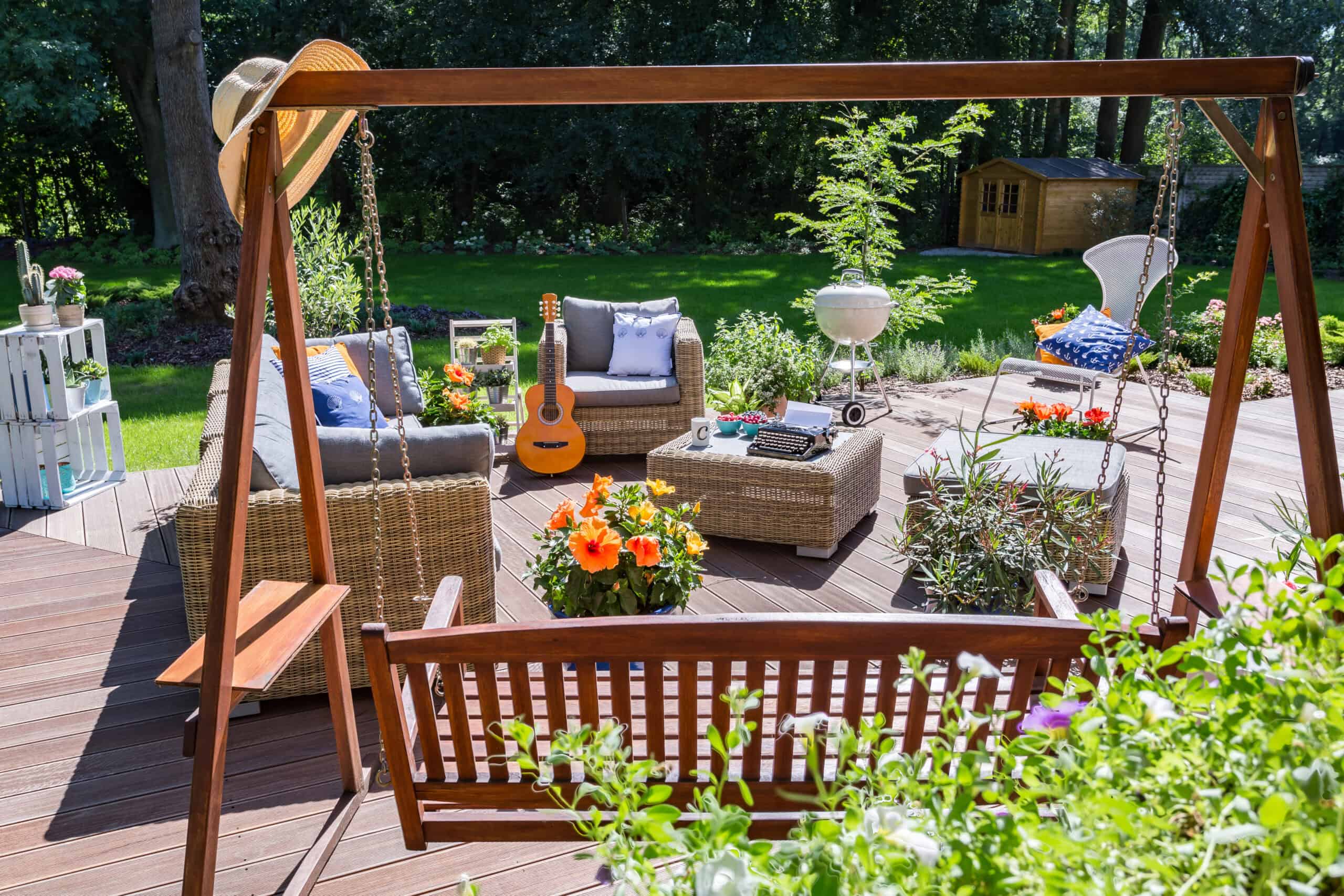 Outdoor patio renovation with stylish furniture and lush greenery.
