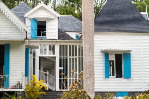 Modern home addition with white siding and blue shutters in Orange County.